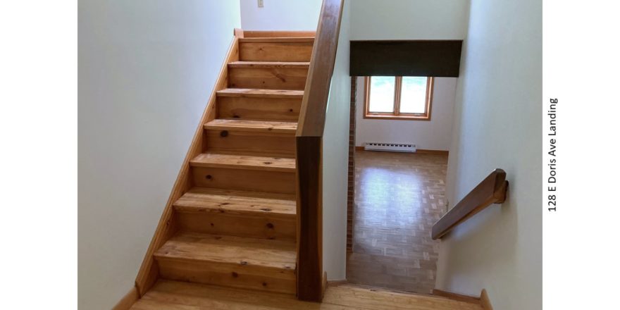 Stair landing with wood stairs and railings