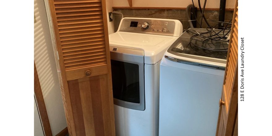 Laundry closet with side-by-side front load washer and top load dryer.