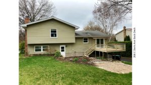 Back yard with lawn, deck and sunken patio with firepit.