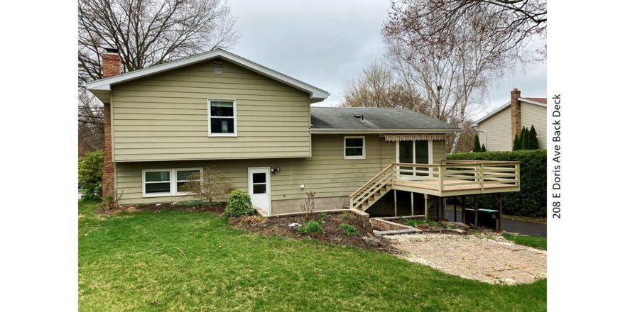 Back yard with lawn, deck and sunken patio with firepit.