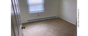 Unfurnished, carpeted bedroom with one window
