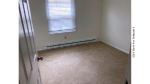 Unfurnished, carpeted bedroom with one window