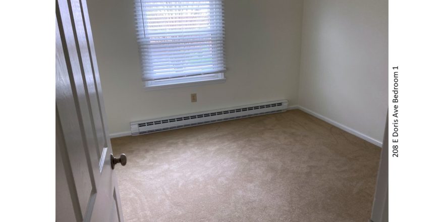 Unfurnished, carpeted bedroom with one window