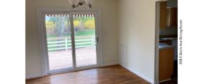 Dining area with hardwood floors, chandelier, and sliding glass door onto back patio