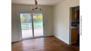 Dining area with hardwood floors, chandelier, and sliding glass door onto back patio