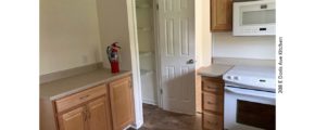 Kitchen with pantry, light wood cabinets, and white appliances