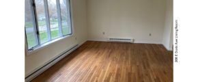 Living room with hardwood flooring and bay window