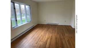 Living room with hardwood flooring and bay window