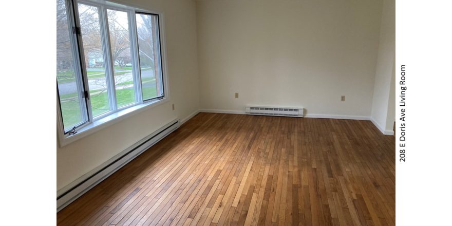 Living room with hardwood flooring and bay window