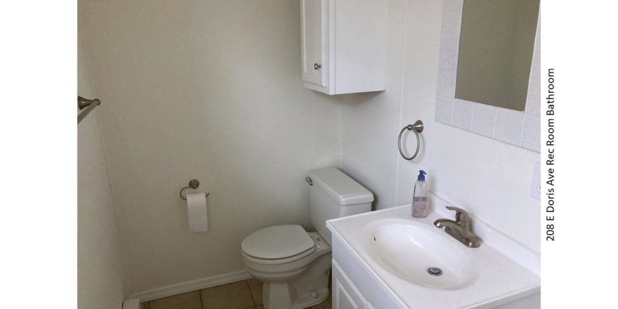 Bathroom with small vanity, toilet, mirror, and medicine cabinet above the toilet