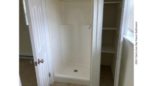 Shower stall with small closet next to it