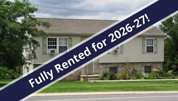 a house with a blue ribbon in front of it