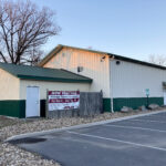white and dark green building with garages