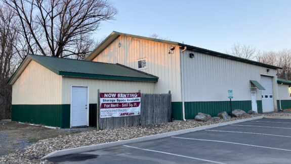 white and dark green building with garages