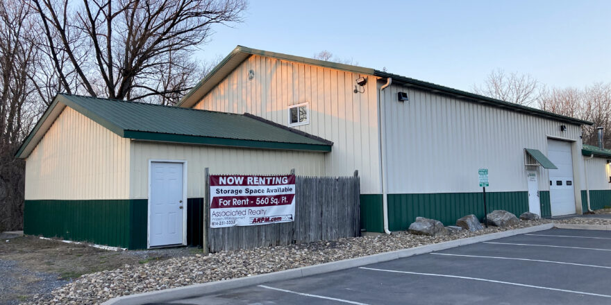 white and dark green building with garages