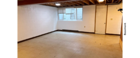 unfurnished basement with tile and wooden beams on ceiling