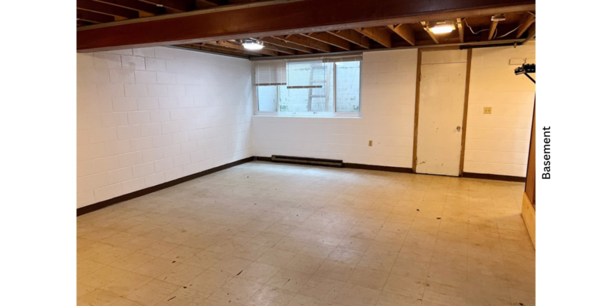 unfurnished basement with tile and wooden beams on ceiling