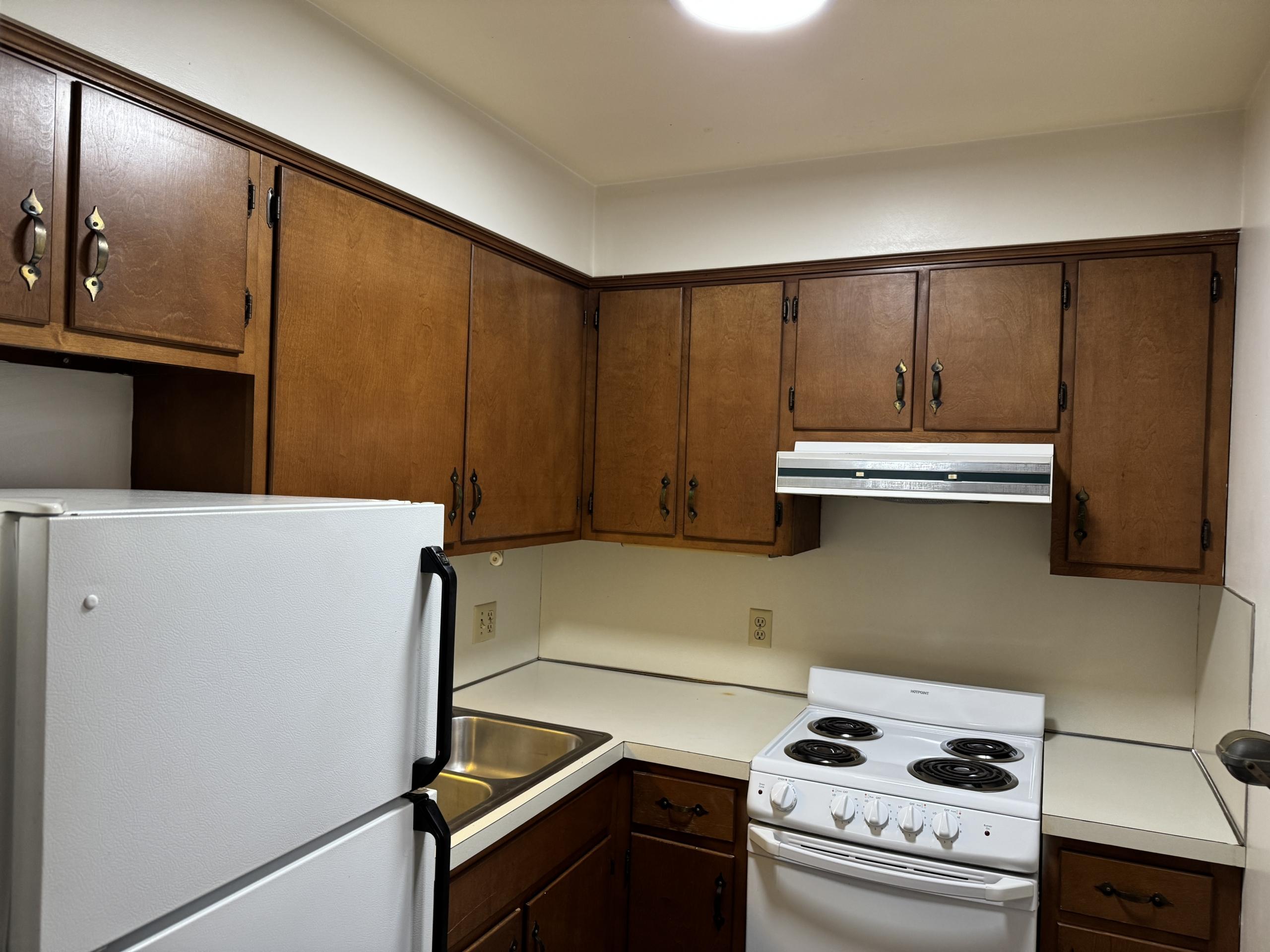 Kitchen with white appliances and wood cabinets