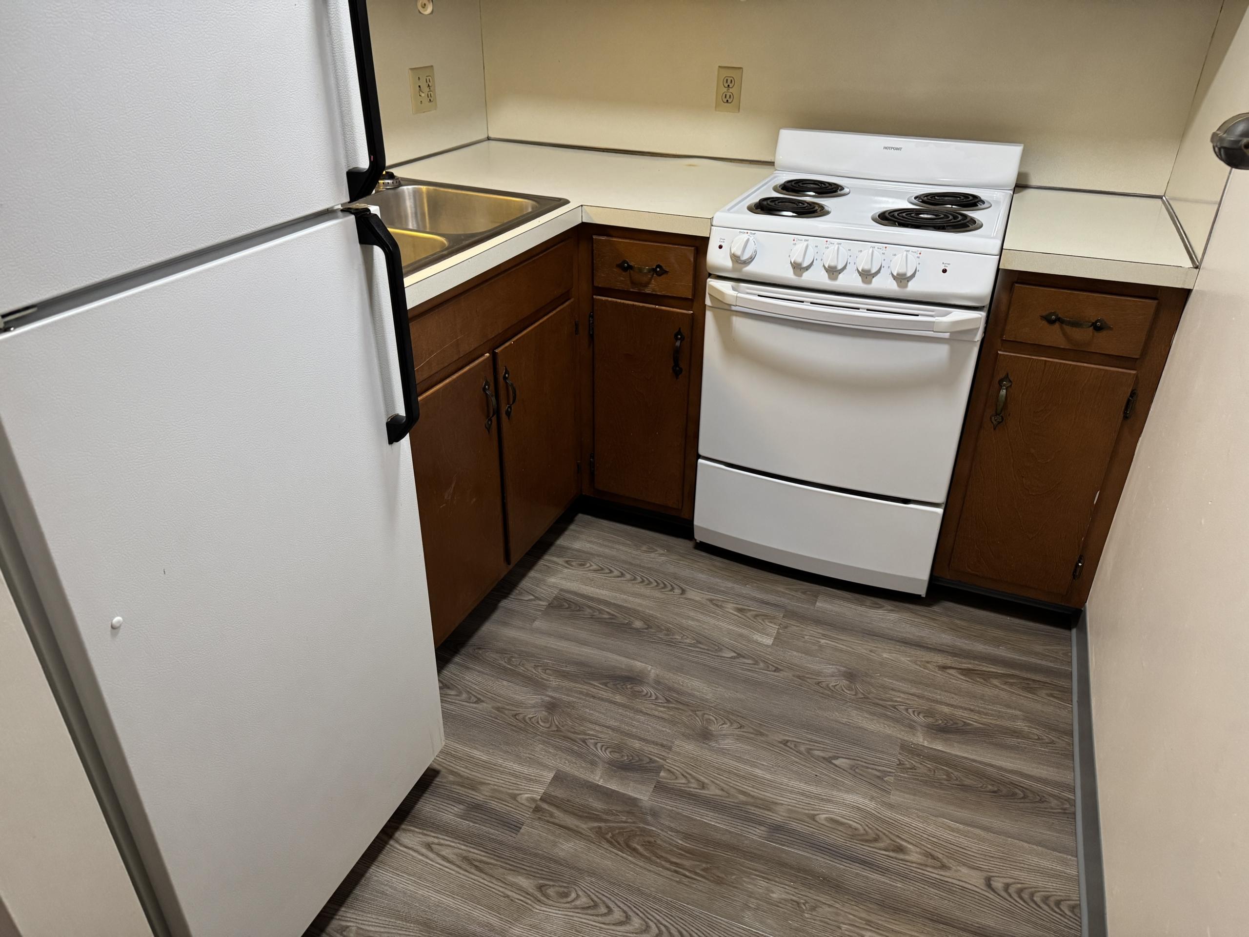 Kitchen with white appliances and wood cabinets