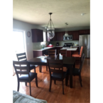 Kitchen with stainless steel appliances, large table and island with seating