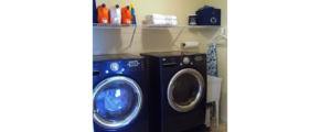 Laundry area with side-by-side washer and dryer and laundry tub.