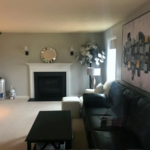 Carpeted, furnished living room with gas fireplace