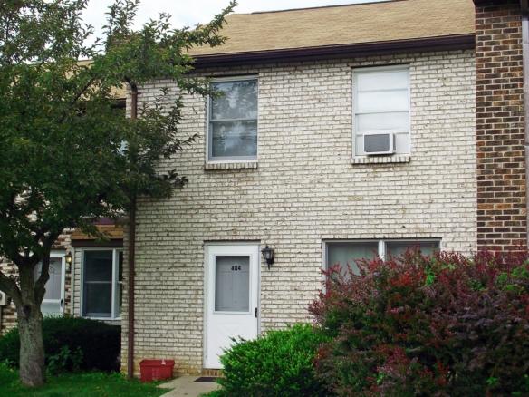 Tan brick townhouse at 404 Gerald St with white screen door