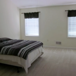 Carpeted bedroom with large bed