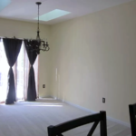 Carpeted dining area with chandelier and skylights