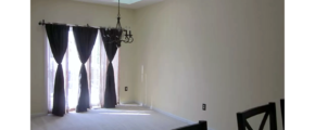 Carpeted dining area with chandelier and skylights