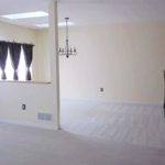 Carpeted dining area with barstool seating