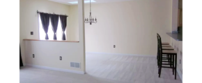 Carpeted dining area with barstool seating