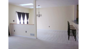 Carpeted dining area with barstool seating