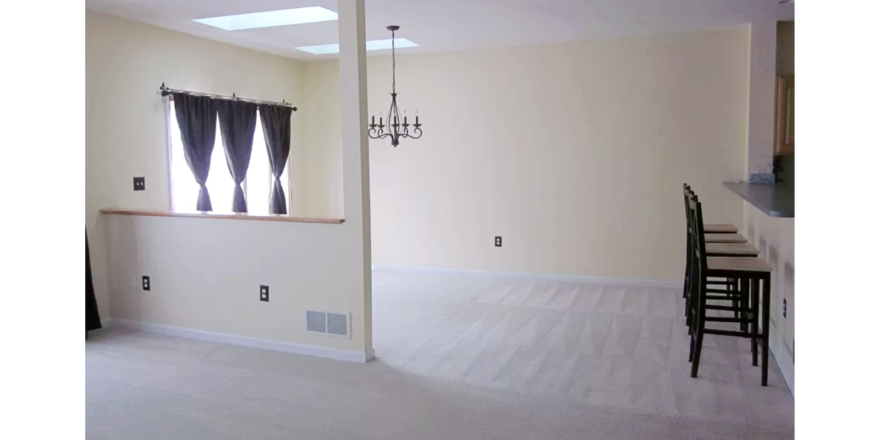 Carpeted dining area with barstool seating