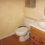 Half bathroom with toilet and vanity