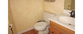 Half bathroom with toilet and vanity