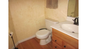 Half bathroom with toilet and vanity