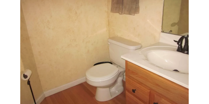 Half bathroom with toilet and vanity