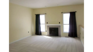 Carpeted living room with fireplace