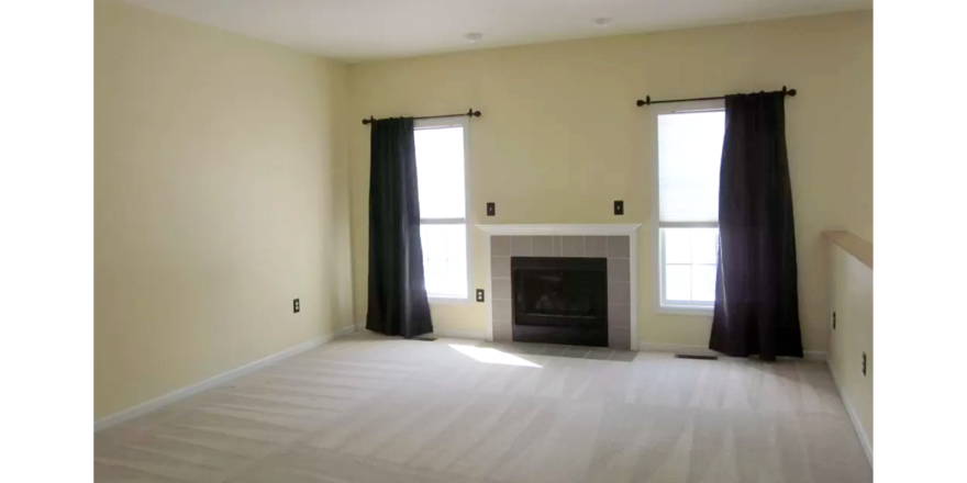 Carpeted living room with fireplace