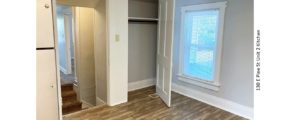 Unfurnished Kitchen with wood-style flooring and a fridge