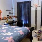 Bedroom with full bed, desk, and chairs