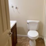 Bathroom with shower stall, vanity, and toilet