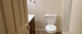 Bathroom with shower stall, vanity, and toilet