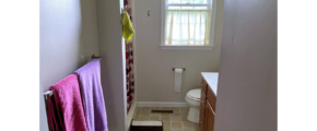 Bathroom with shower stall, vanity, and toilet