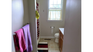 Bathroom with shower stall, vanity, and toilet