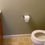 Half bathroom with vanity and toilet
