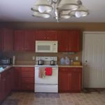 Kitchen with wood-tone cabinets and white appliances