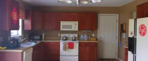 Kitchen with wood-tone cabinets and white appliances