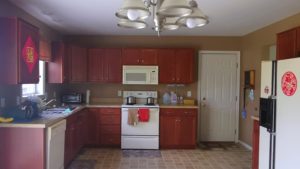 Kitchen with wood-tone cabinets and white appliances